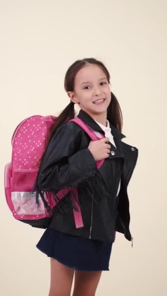 Little school girl with backpack and uniform on white back — 비디오