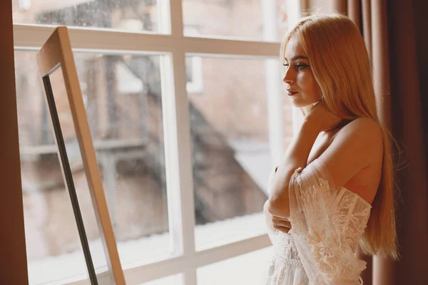 The beautiful young woman posing in a wedding dress — Stock Photo, Image