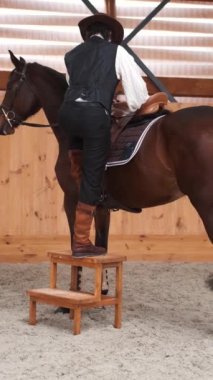 Old cowboy in a hat riding a horse