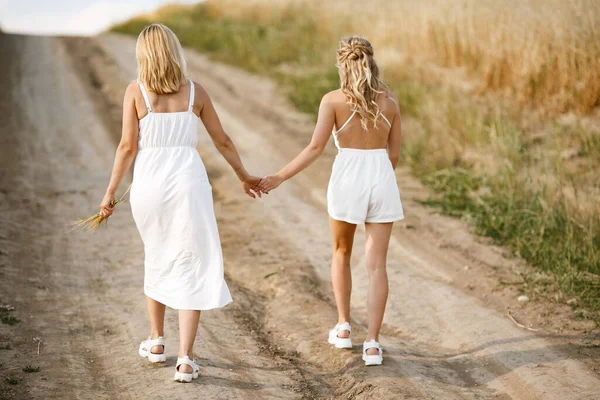 Mother with beautiful daughter in a autumn field — Stock Photo, Image