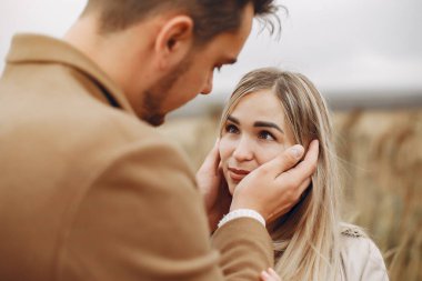 Güzel bir çift sonbahar tarlasında vakit geçirir.