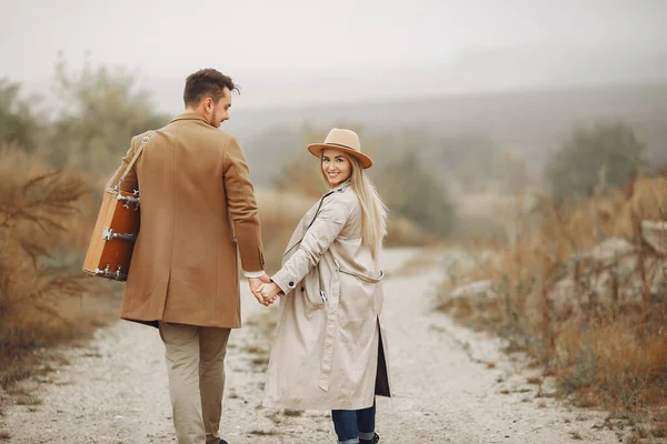 Beautiful couple spend time in a autumn field — Stock Photo, Image