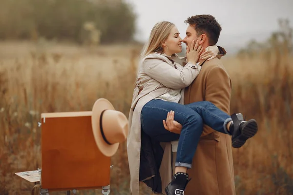 Beautiful couple spend time in a autumn field — Stock Photo, Image