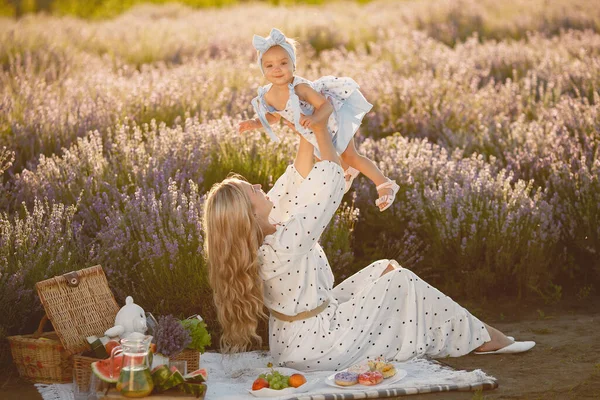 Little girl with her mother in a lavender field — Stock Photo, Image