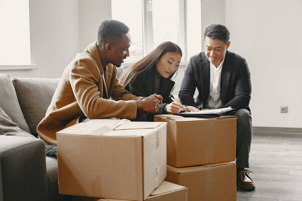 Realtor Explaining Agreement To Couple In New Apartment