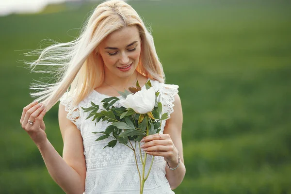 Žena v elegantních šatech stojící na letním poli — Stock fotografie