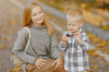 Anne ve küçük oğlu sonbahar tarlasında oynuyorlar.