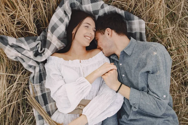 Pareja feliz enamorada en el campo de trigo al atardecer — Foto de Stock