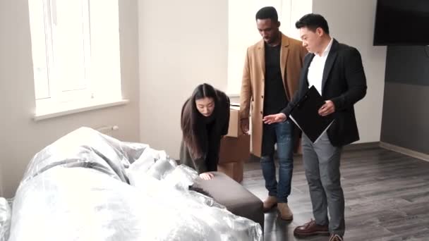 Realitní makléř vysvětlující dohodu na pár v novém bytě — Stock video