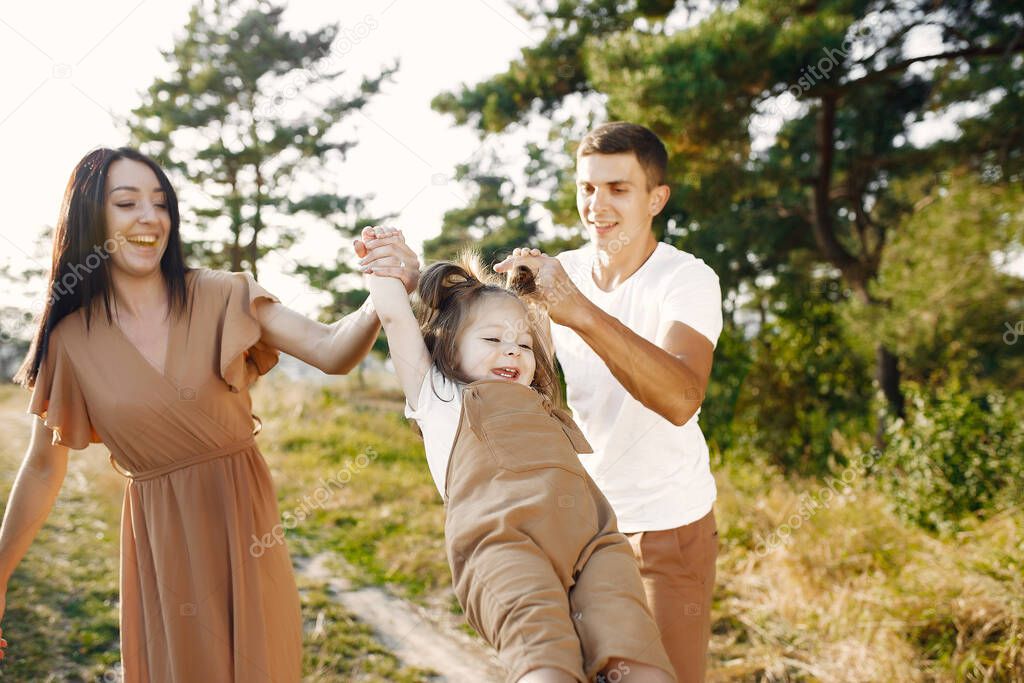 Cute family playing in a autumn field