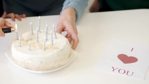 Unrecognizable person lighting the candles on cake — Stock Video
