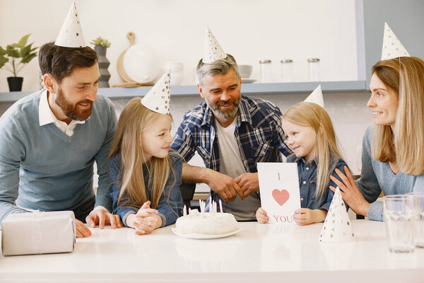 Family celebrating birthday in the kitchen