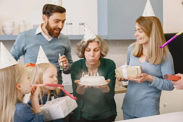 Família comemorando aniversário de sua avó na cozinha — Fotografia de Stock