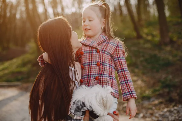 Mother with daughter in a spring forest with dog — Stock Photo, Image