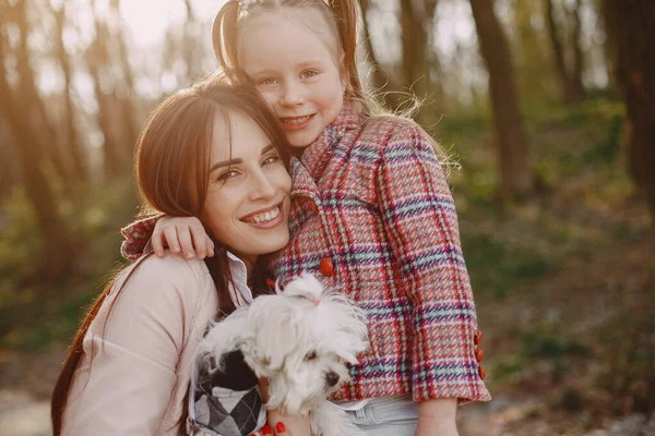 Mother with daughter in a spring forest with dog — Stock Photo, Image