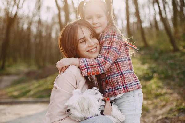 Mother with daughter in a spring forest with dog — Stock Photo, Image