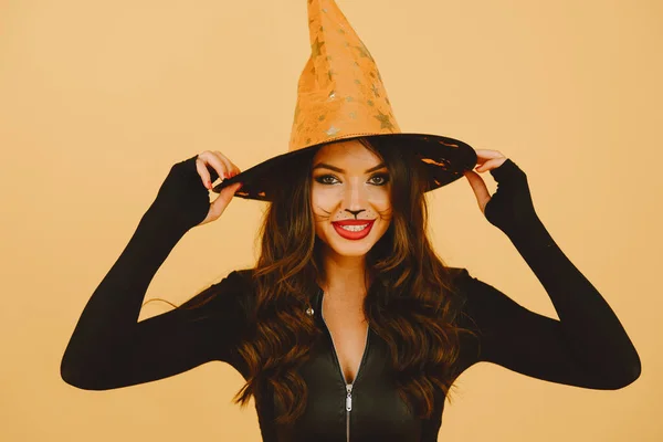 Jeune femme dans haloween pose de costume sur fond de couleur — Photo