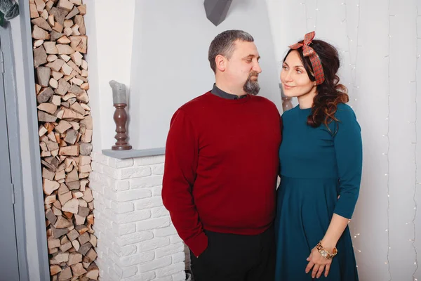 Adult family standing in a room near fireplace — Stock Photo, Image