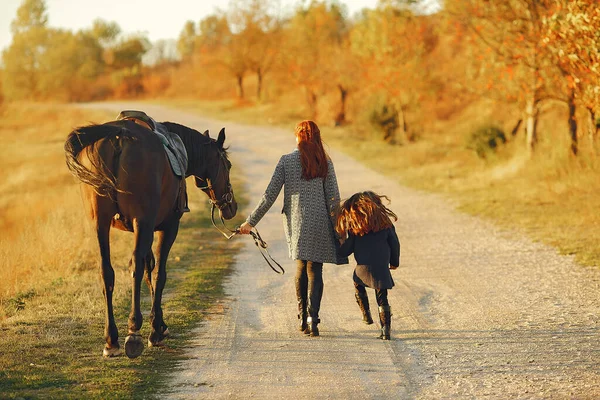 Matka i córka na polu gry z koniem — Zdjęcie stockowe