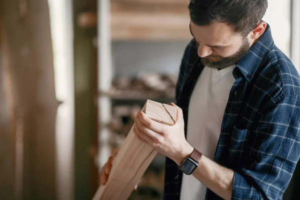 Man in de werkplaats met een hout — Stockfoto