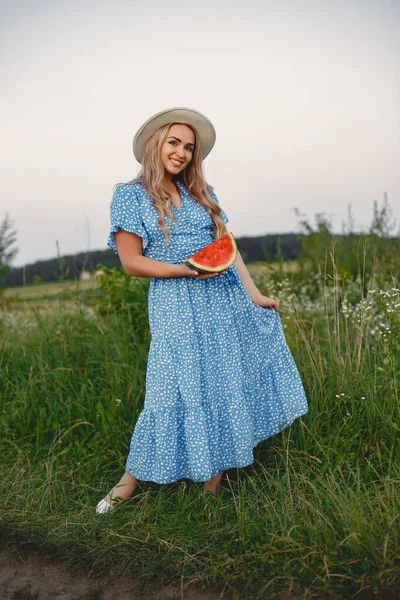 Woman in a blue dress in a wheat field — Stock Photo, Image