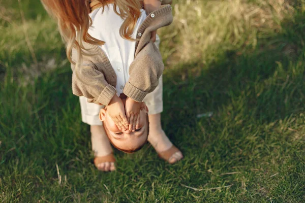 Mutter mit kleinem Sohn spielt auf einem Sommerfeld — Stockfoto