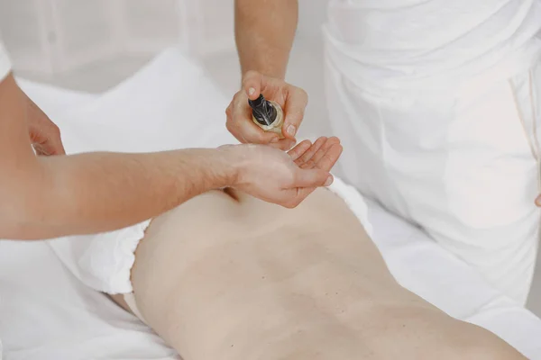 Four hands do massage to female body — Stock Photo, Image