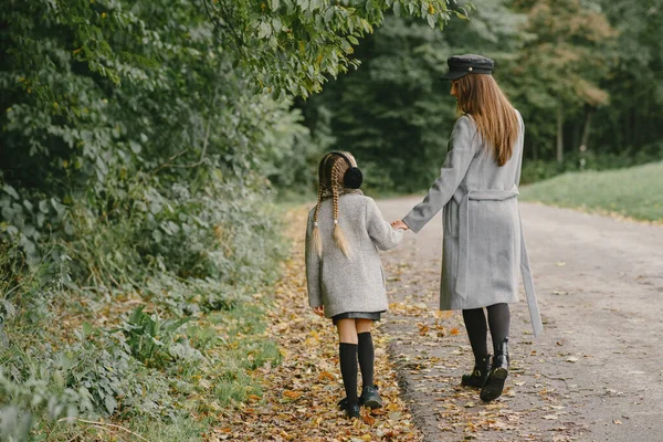 Cute and stylish family in a autumn park — Stock Photo, Image