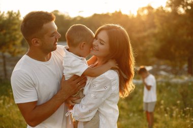 Yaz tarlasında oynayan sevimli bir aile.