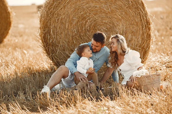 Family in a picnic in a wheat field