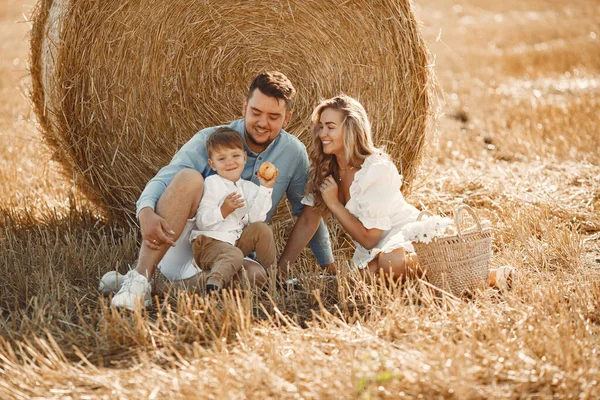 Family in a picnic in a wheat field