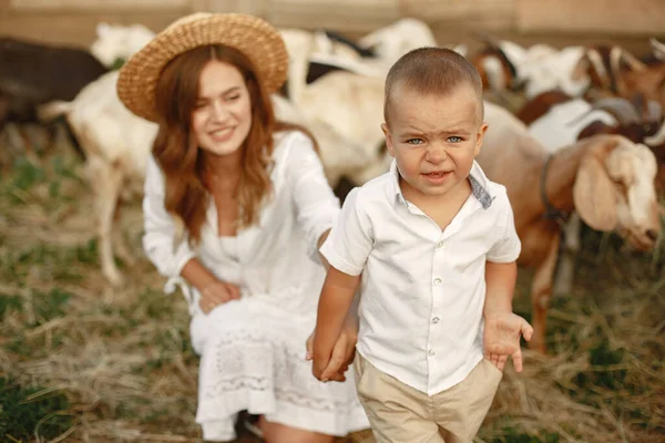 Family spending time together outside with a goat — Stock Photo, Image