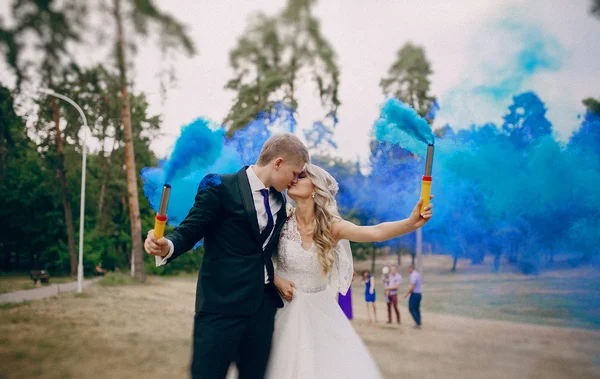 Wedding couple runs blue smoke