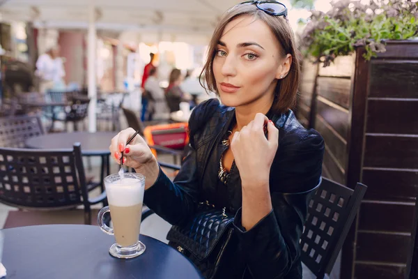 漂亮的女孩在一家咖啡馆喝一杯卡布奇诺咖啡 — 图库照片