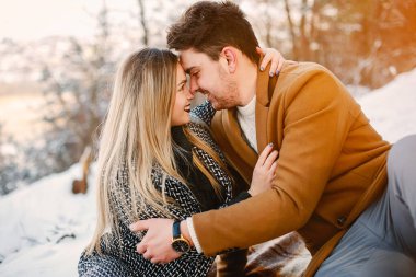 karlı bir kış gününde parkta piknik olan mutlu genç çift