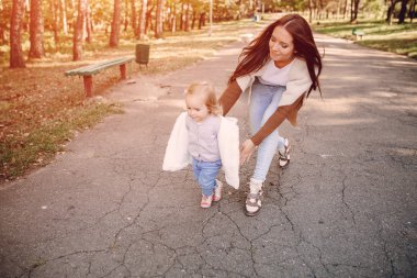Genç bir aile parkta yürüyor.