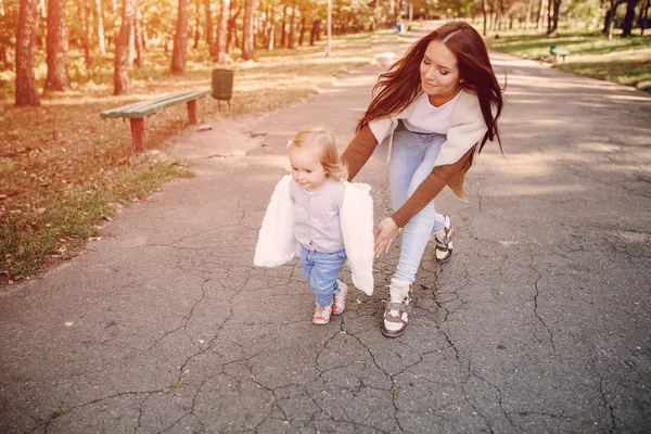 Young family walking in the park — Stock Photo, Image