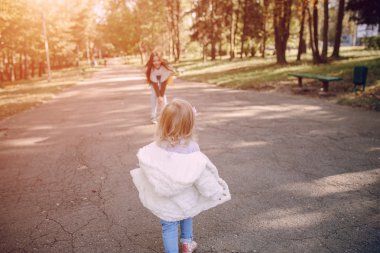 Genç bir aile parkta yürüyor.