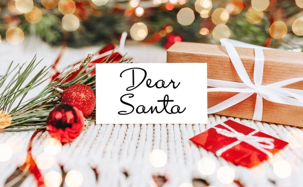 Merry christmas and merry new year concept with gift boxes and greeting card with text Dear Santa