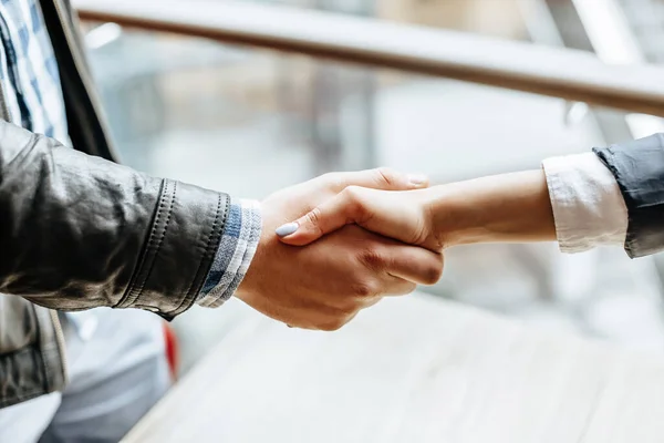 Man and woman hand shaking. Handshake after good cooperation, Businesswoman Shaking hands with Professional businessman after discussing good deal of contract. Business concept.