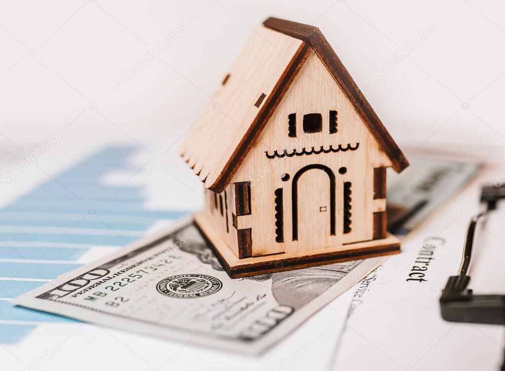 House miniature model and money on documents. Investment, real estate, home, housing