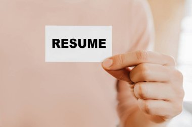 Özgeçmişli bir kartvizit tutan adam