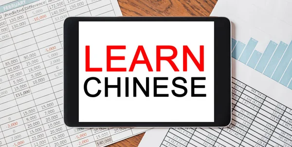 Tablet with text Learn Chinese on your desktop with documents, reports and graphs. study and education concept