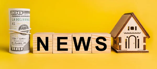 NEWS with house miniature model and money on a yellow background. The concept of business, finance, credit, tax , real estate, home, housing