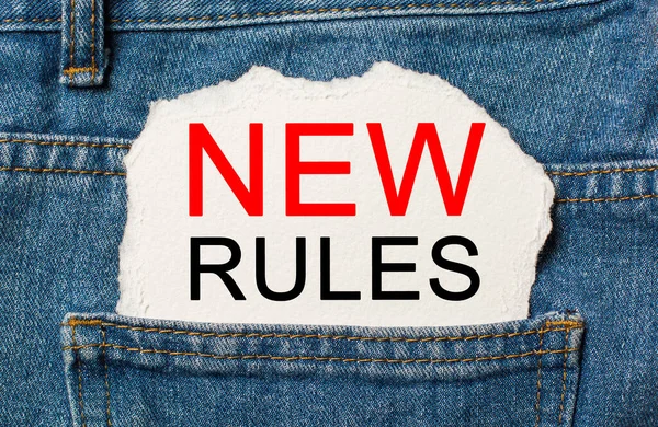 new rules on torn paper background on jeans business and finance concept