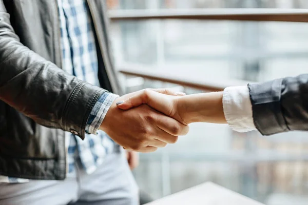 Man and woman hand shaking. Handshake after good cooperation, Businesswoman Shaking hands with Professional businessman after discussing good deal of contract. Business concept.