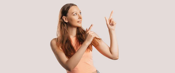 Portrait Smiling Girl Pointing Finger Side White Isolated Background Positive — Stock Photo, Image