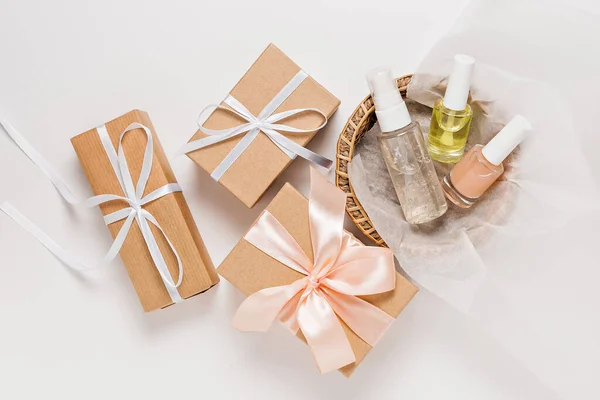 Organik kozmetik ürünleri ve bayram için hediyeler. Düz yerde, cam pompa şişesi, fırça kavanozu, beyaz arka planda kağıt sepette nemlendirici serum. Doğal Kozmetik SPA