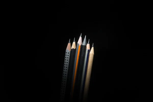 six different black pencils