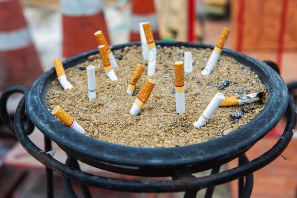 Smoked Cigarettes Butts in a Dirty Ashtray Big Bin. Life concept — Stock Photo, Image